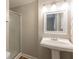 Bathroom featuring a vanity sink with white pedestal and a shower with glass door at 110 Valley View Ct, Tyrone, GA 30290
