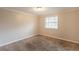 Neutral bedroom featuring carpet floors and a window with blinds at 110 Valley View Ct, Tyrone, GA 30290