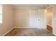 Bedroom with carpet, white doors and trim, window and access to additional rooms at 110 Valley View Ct, Tyrone, GA 30290