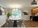 Bright dining area featuring a modern chandelier, marble table, and views of the outdoors at 110 Valley View Ct, Tyrone, GA 30290