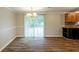 Dining area with hardwood floors, contemporary lighting, and sliding glass door to the backyard at 110 Valley View Ct, Tyrone, GA 30290