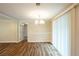 Bright dining room featuring hardwood floors, modern lighting, and large window at 110 Valley View Ct, Tyrone, GA 30290