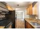 Well-lit kitchen showcasing dark appliances and granite countertops with a view of the dining area at 110 Valley View Ct, Tyrone, GA 30290