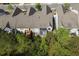 A home featuring a rear deck, surrounded by mature trees, offering a private outdoor space at 123 Heritage Pointe, Woodstock, GA 30189