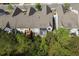 Aerial view of back of home with a deck and patio surrounded by green trees at 123 Heritage Pointe, Woodstock, GA 30189