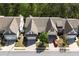 Aerial view of home with well maintained landscaping and driveway with a red car at 123 Heritage Pointe, Woodstock, GA 30189