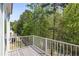 Balcony with wood deck offers a great view of the surrounding trees at 123 Heritage Pointe, Woodstock, GA 30189