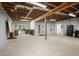 Finished basement with concrete floors and an exposed ceiling with wood rafters at 123 Heritage Pointe, Woodstock, GA 30189
