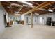 The unfinished basement with concrete floor has exposed beams at 123 Heritage Pointe, Woodstock, GA 30189