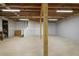 Unfinished basement with concrete floor, exposed ceiling and support beams at 123 Heritage Pointe, Woodstock, GA 30189