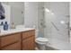 Bathroom featuring glass shower door, white marbled walls, and wood cabinets at 123 Heritage Pointe, Woodstock, GA 30189