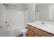 Bright bathroom featuring a tub-shower combination, and vanity with wood cabinets at 123 Heritage Pointe, Woodstock, GA 30189