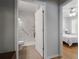 A modern bathroom showcasing a tiled walk-in shower with accessible features and a stylish doorway at 123 Heritage Pointe, Woodstock, GA 30189