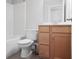 Bathroom featuring a tub, toilet, vanity with light wood cabinets and modern fixtures at 123 Heritage Pointe, Woodstock, GA 30189