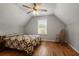 Attic bedroom boasting unique architecture, wooden floors, and a cozy rocking chair at 123 Heritage Pointe, Woodstock, GA 30189