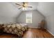 Bedroom featuring a ceiling fan, wood floors, rocking chair and natural light at 123 Heritage Pointe, Woodstock, GA 30189