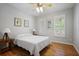 Bedroom with hardwood flooring, ceiling fan, and natural light from window with shutters at 123 Heritage Pointe, Woodstock, GA 30189