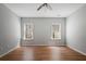 Bright bedroom featuring wood laminate floors and two windows offering ample natural light at 123 Heritage Pointe, Woodstock, GA 30189