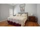 Serene bedroom featuring hardwood floors, natural light, and minimalist decor creating a cozy retreat at 123 Heritage Pointe, Woodstock, GA 30189
