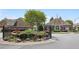 Community entrance featuring well-maintained landscaping and a water feature at 123 Heritage Pointe, Woodstock, GA 30189