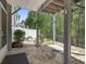 Covered patio features a stone floor, lush landscaping, and a tranquil outdoor space for relaxation at 123 Heritage Pointe, Woodstock, GA 30189