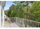 Relax on the deck with scenic views of the backyard surrounded by trees and nature at 123 Heritage Pointe, Woodstock, GA 30189