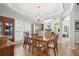 Elegant dining room with hardwood floors, a chandelier, and large windows, creating a refined space for Gathering meals at 123 Heritage Pointe, Woodstock, GA 30189