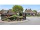Community entrance featuring manicured landscaping, and water feature at 123 Heritage Pointe, Woodstock, GA 30189