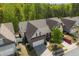 Charming home featuring a two-car garage and attractive landscaping, complemented by lush, mature trees at 123 Heritage Pointe, Woodstock, GA 30189
