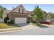 Charming two-story brick home with a well-maintained lawn and a two-car garage, located in a desirable neighborhood at 123 Heritage Pointe, Woodstock, GA 30189