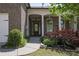 Inviting front entrance with brick columns, garden bed, and well-manicured landscaping at 123 Heritage Pointe, Woodstock, GA 30189