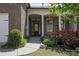 Inviting front entrance with a brick facade, well-manicured landscaping, and a covered porch, creating a welcoming curb appeal at 123 Heritage Pointe, Woodstock, GA 30189