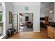 Open hallway leading to sunroom and living room area featuring hardwood floors and bright natural light at 123 Heritage Pointe, Woodstock, GA 30189