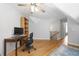 Home office featuring hardwood floors, large desk, natural light and a spiral staircase at 123 Heritage Pointe, Woodstock, GA 30189