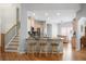 Open-concept kitchen featuring a breakfast bar with seating, stainless steel appliances, and hardwood floors, perfect for entertaining at 123 Heritage Pointe, Woodstock, GA 30189