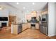 Spacious kitchen with stainless appliances, granite counters, and hardwood floors at 123 Heritage Pointe, Woodstock, GA 30189