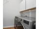 Modern laundry room with white cabinets and stainless steel appliances at 123 Heritage Pointe, Woodstock, GA 30189