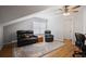 Attic living room featuring hardwood floors, ceiling fan, and comfortable seating at 123 Heritage Pointe, Woodstock, GA 30189
