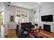Comfortable living room with hardwood floors, fireplace, decorative lighting, and a view to a bedroom at 123 Heritage Pointe, Woodstock, GA 30189