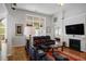 Comfortable living room featuring hardwood floors, fireplace, large windows and comfortable furnishings at 123 Heritage Pointe, Woodstock, GA 30189