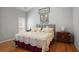 Serene main bedroom with hardwood floors, natural light, and neutral decor for a relaxing retreat at 123 Heritage Pointe, Woodstock, GA 30189