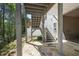 Outdoor patio with stone floor providing access to backyard and stairs to deck for entertaining at 123 Heritage Pointe, Woodstock, GA 30189