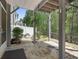 Covered stone patio with open view of backyard landscaping and partial fence at 123 Heritage Pointe, Woodstock, GA 30189