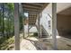 Covered outdoor patio with stone flooring and view of trees at 123 Heritage Pointe, Woodstock, GA 30189