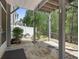 Covered stone patio with manicured landscaping and wooded views at 123 Heritage Pointe, Woodstock, GA 30189