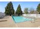 A community pool with lounge chairs and a pool risk sign at 123 Heritage Pointe, Woodstock, GA 30189