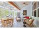 Inviting sunroom featuring a glass ceiling, tile flooring, comfortable seating and dining area at 123 Heritage Pointe, Woodstock, GA 30189