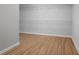 Bright walk-in closet with laminate wood floors and built-in shelving at 123 Heritage Pointe, Woodstock, GA 30189