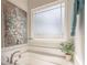 A bright bathroom shows a frosted window above the bathtub at 259 Eason St, Bowdon, GA 30108