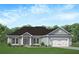Charming single-story home featuring a two-car garage and a welcoming, landscaped front yard at 259 Eason St, Bowdon, GA 30108